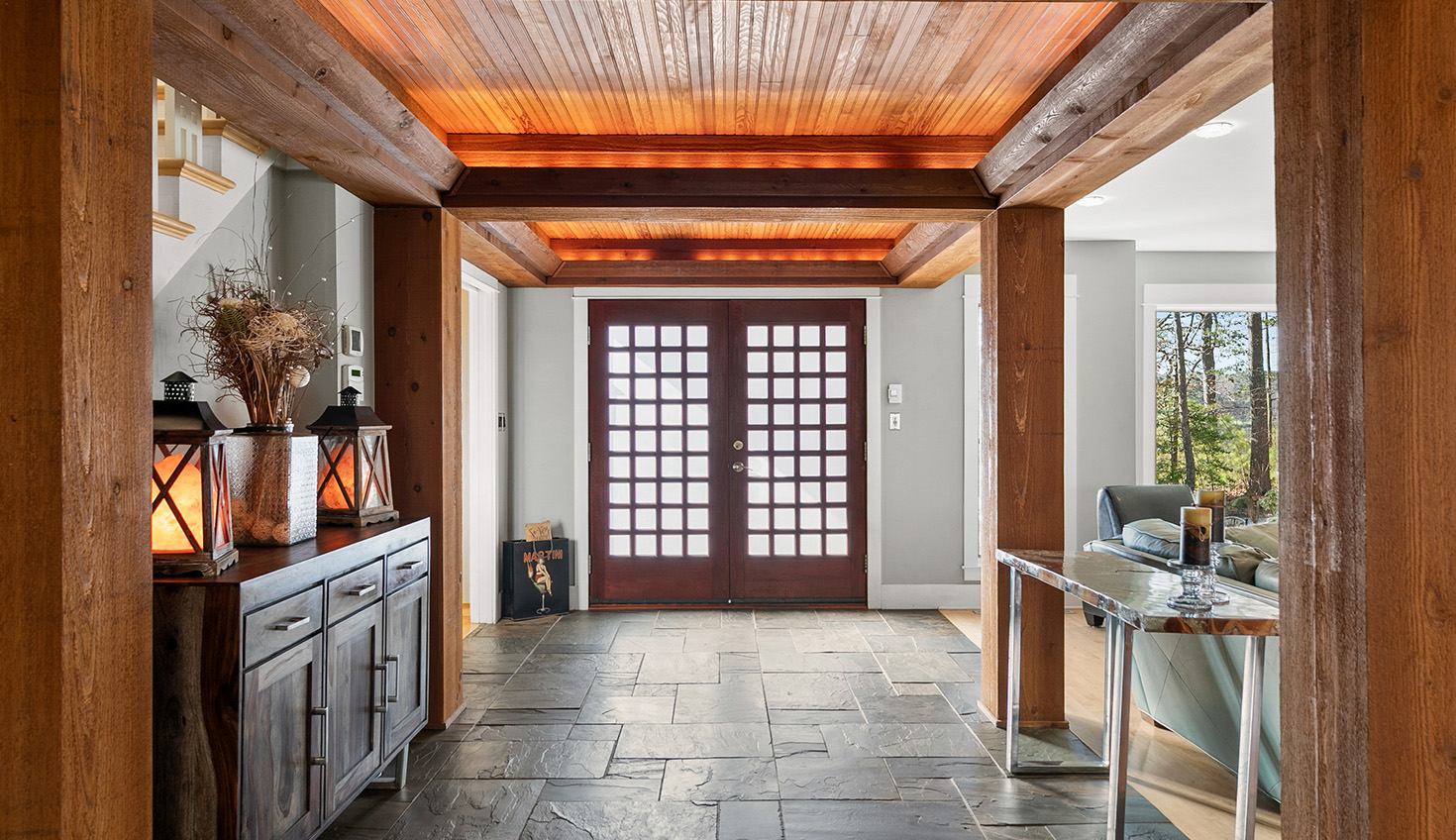a long hallway with a wooden ceiling and tile flooring
