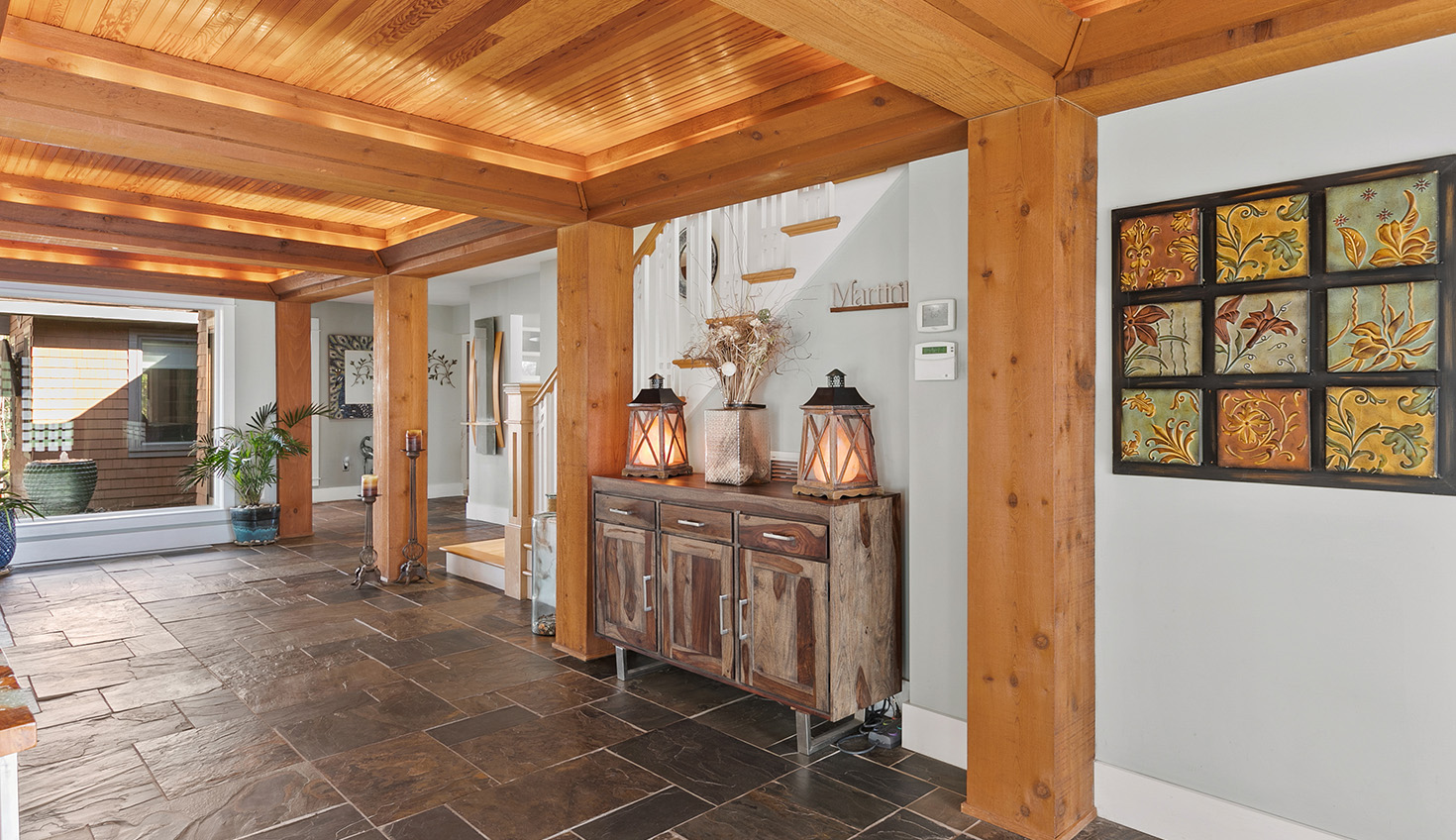 a living room filled with furniture and a wooden ceiling