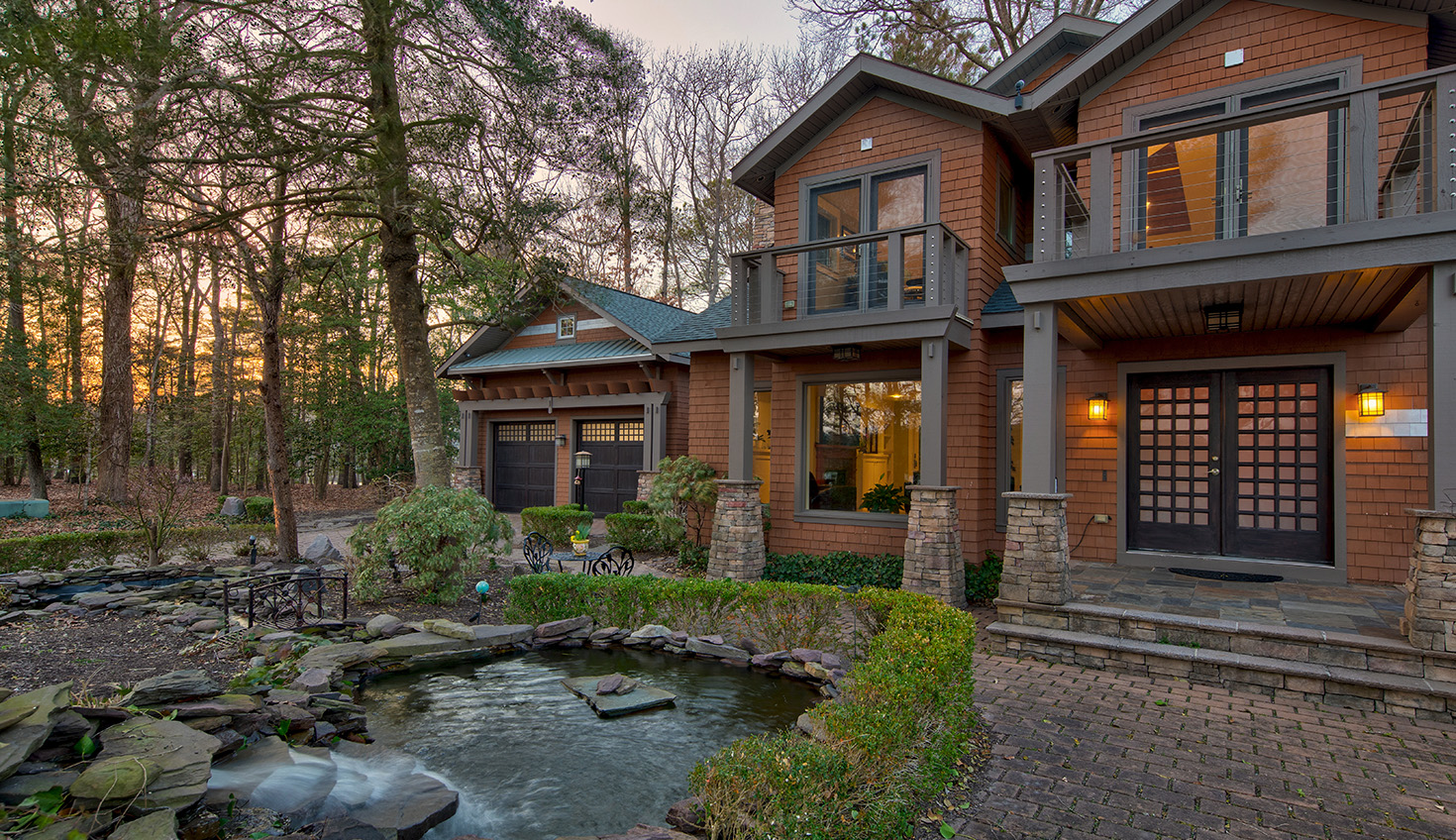a house with a pond in front of it
