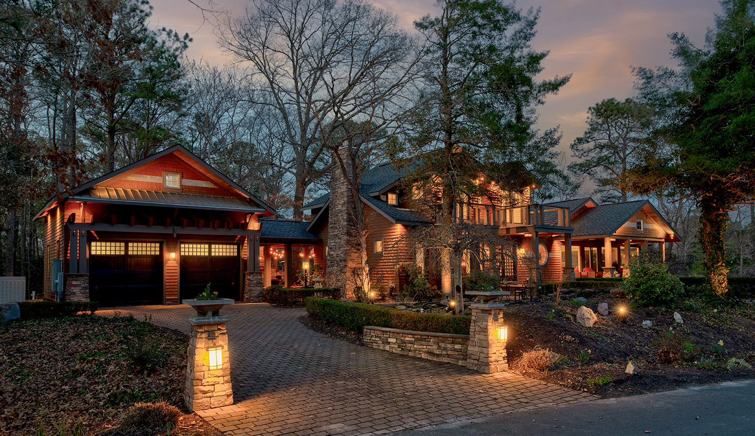 a large house with a driveway surrounded by trees