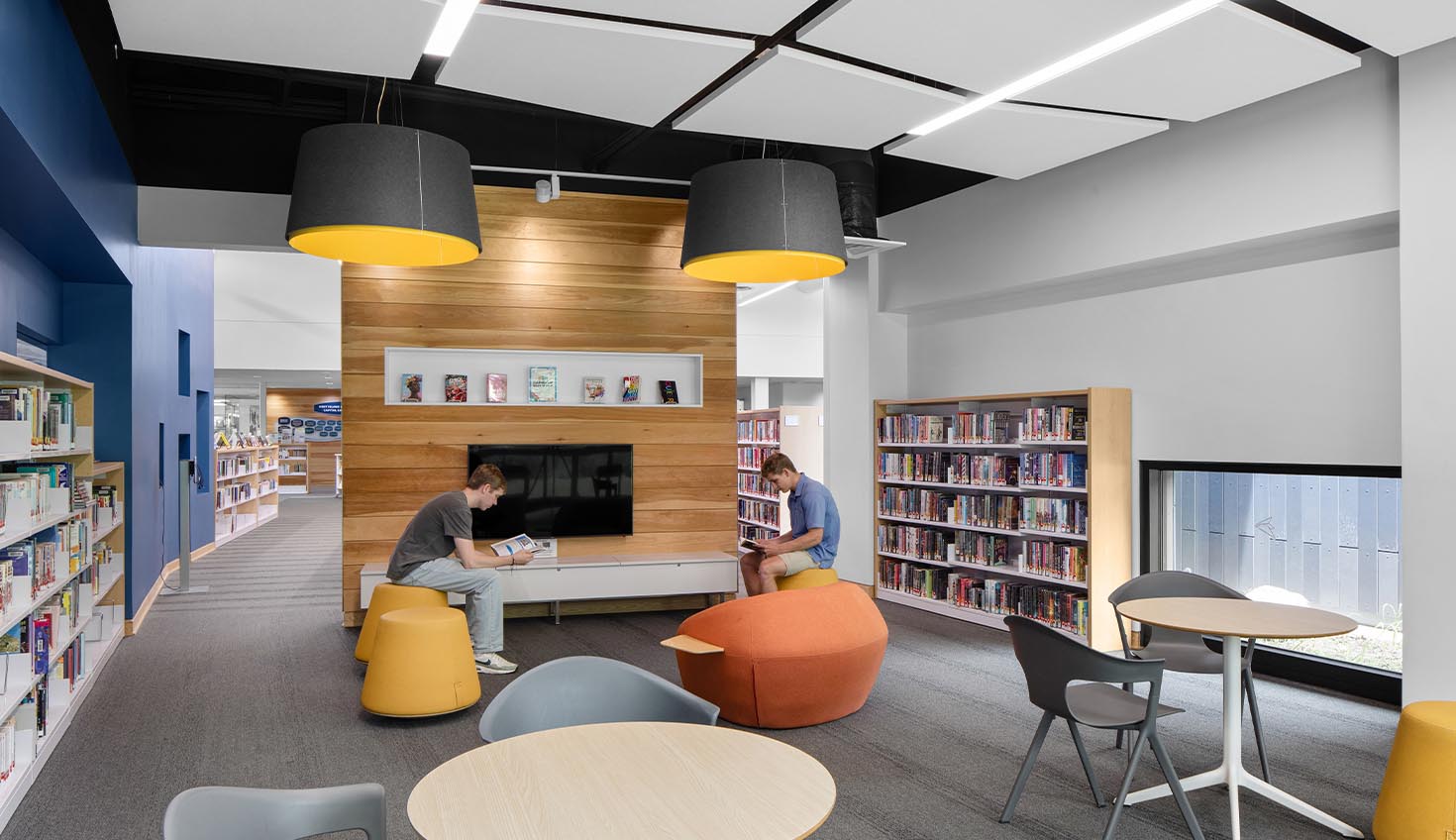 a library filled with lots of books and furniture