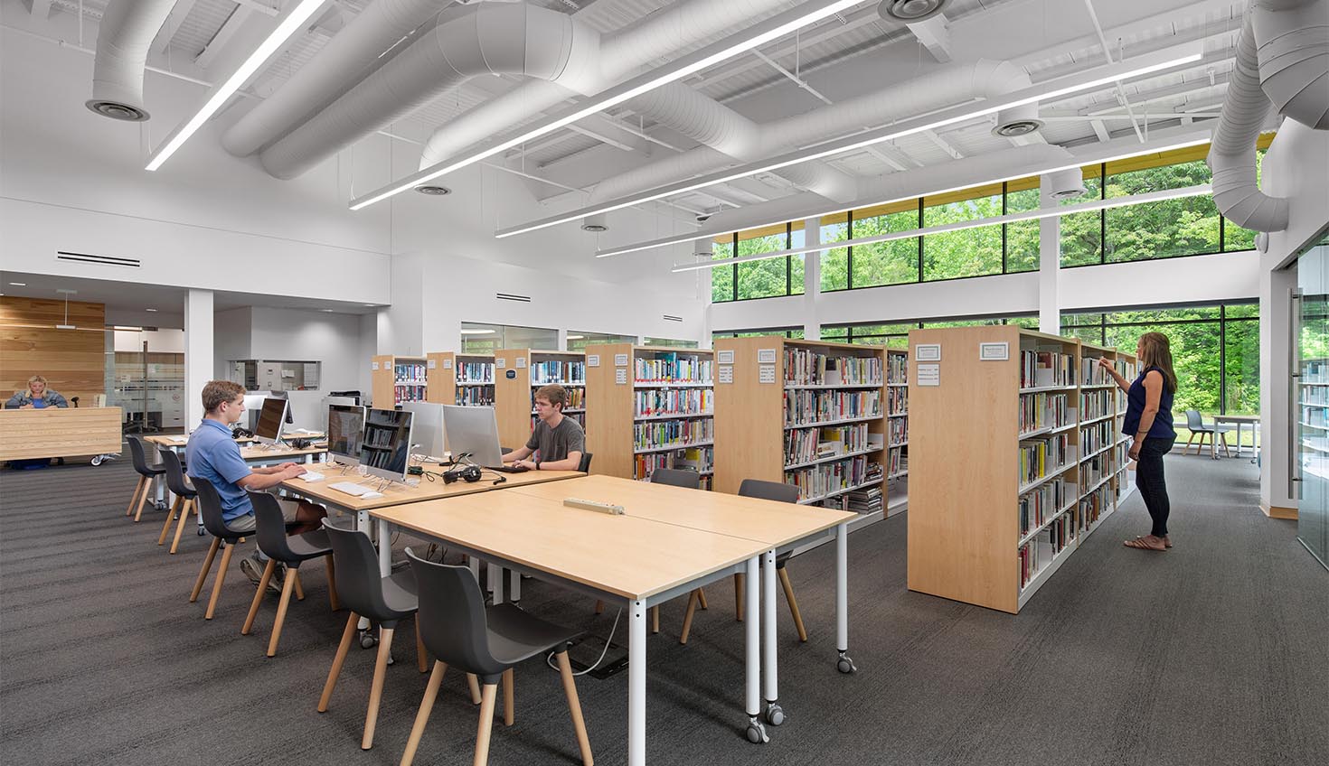 a library filled with lots of books and people
