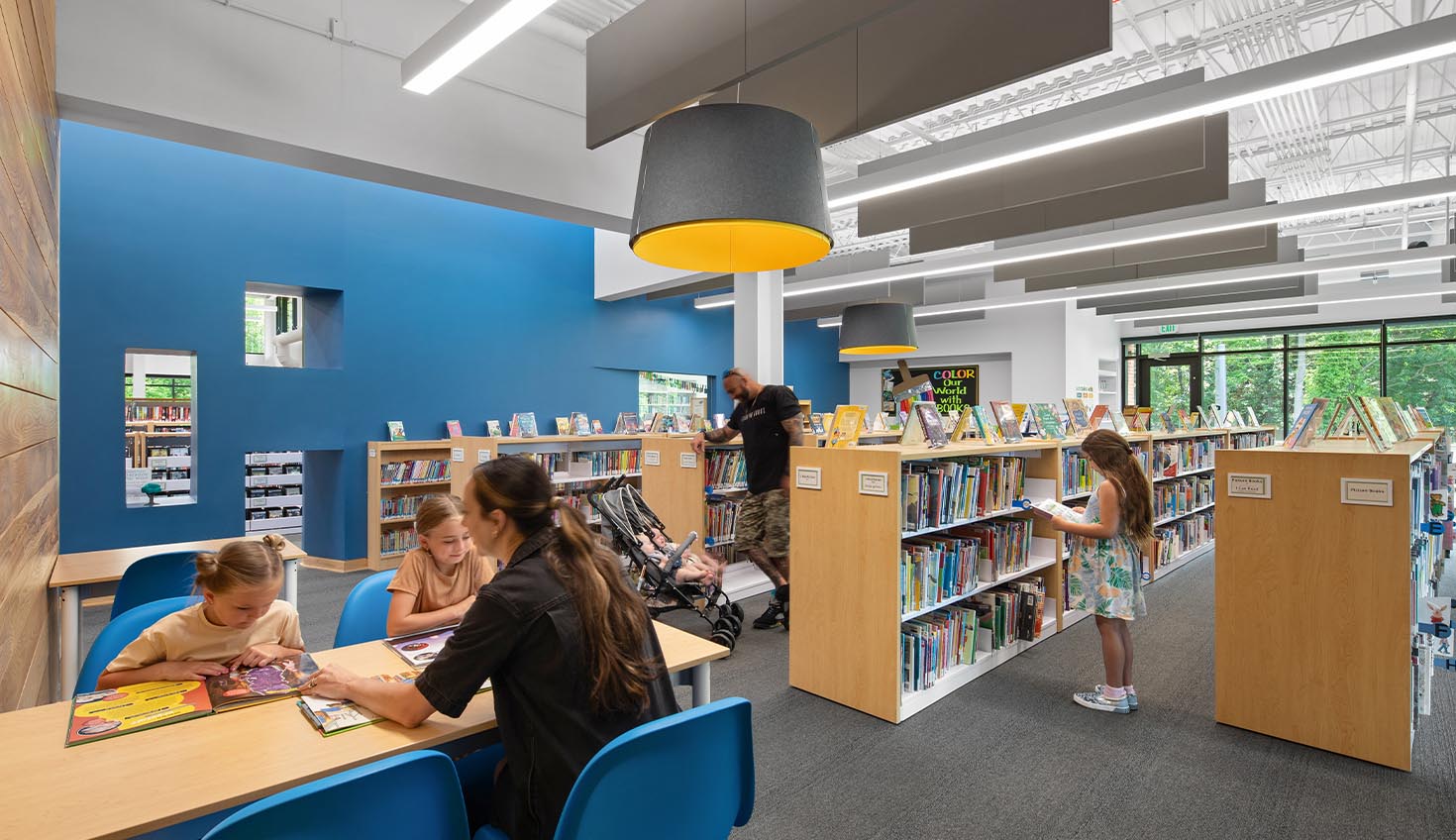 a group of people sitting at a table in a library