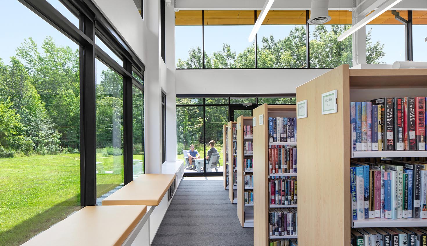 a library filled with lots of books and lots of windows