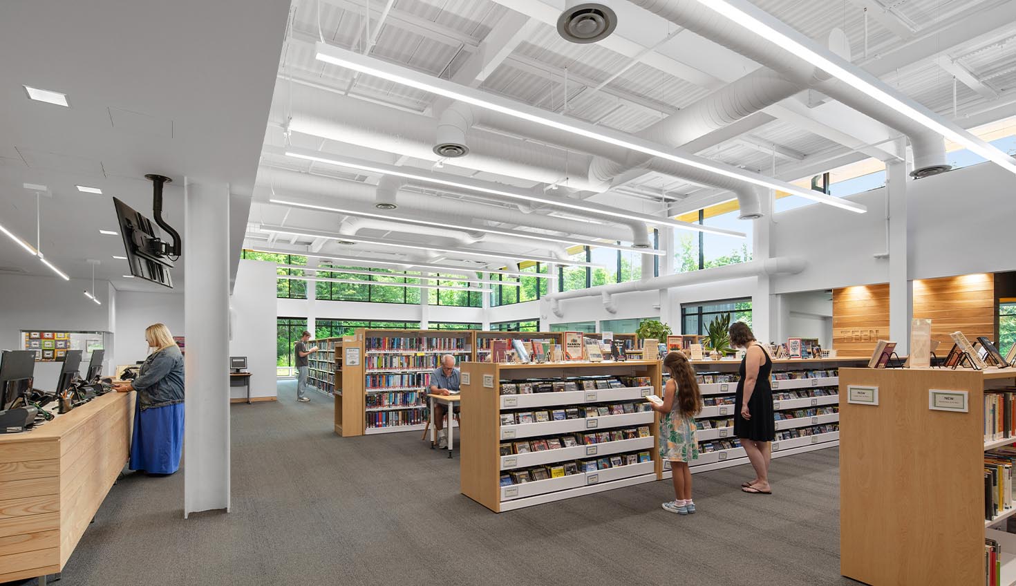 a library filled with lots of books and people