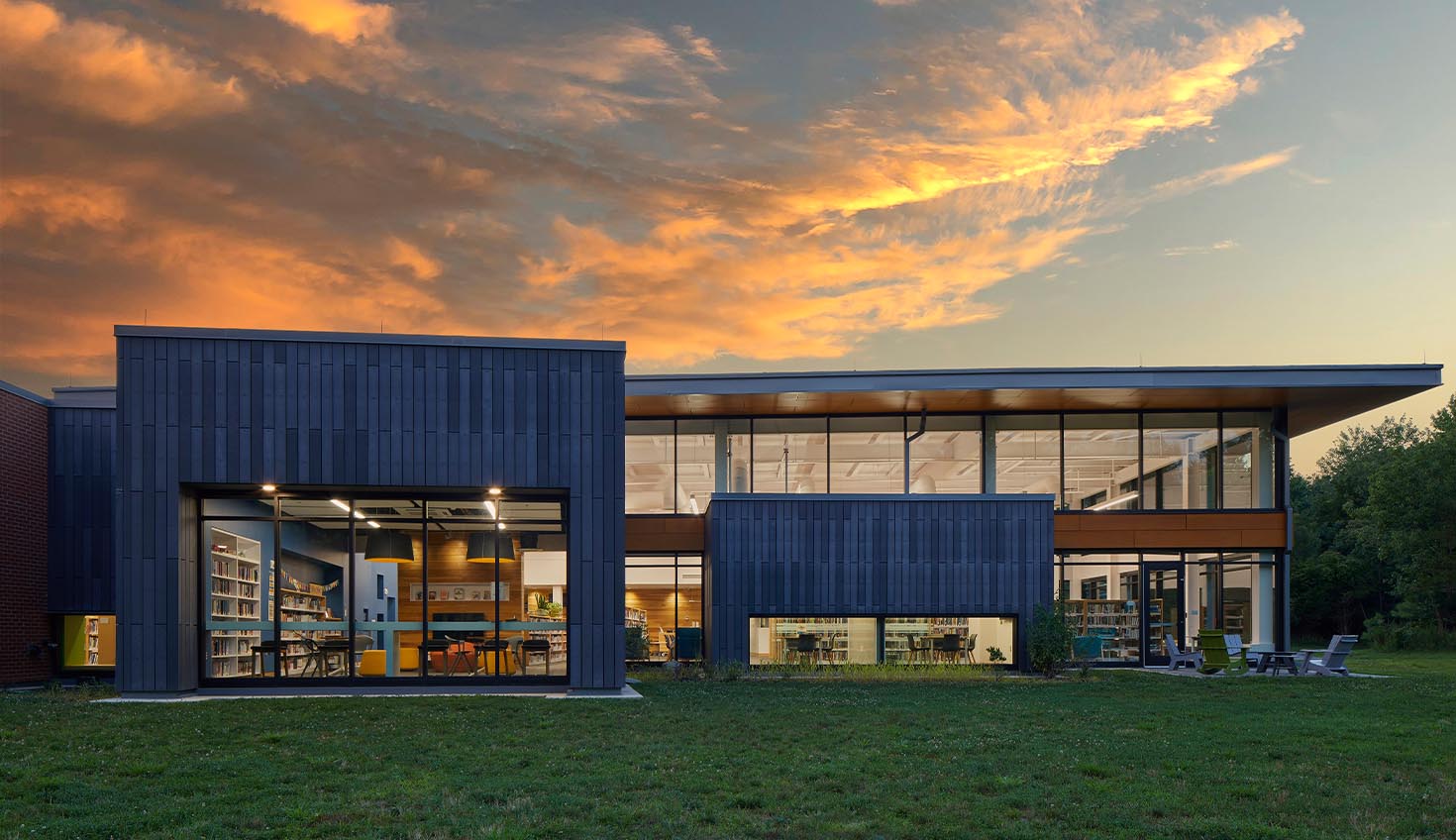 a large building with lots of windows and grass