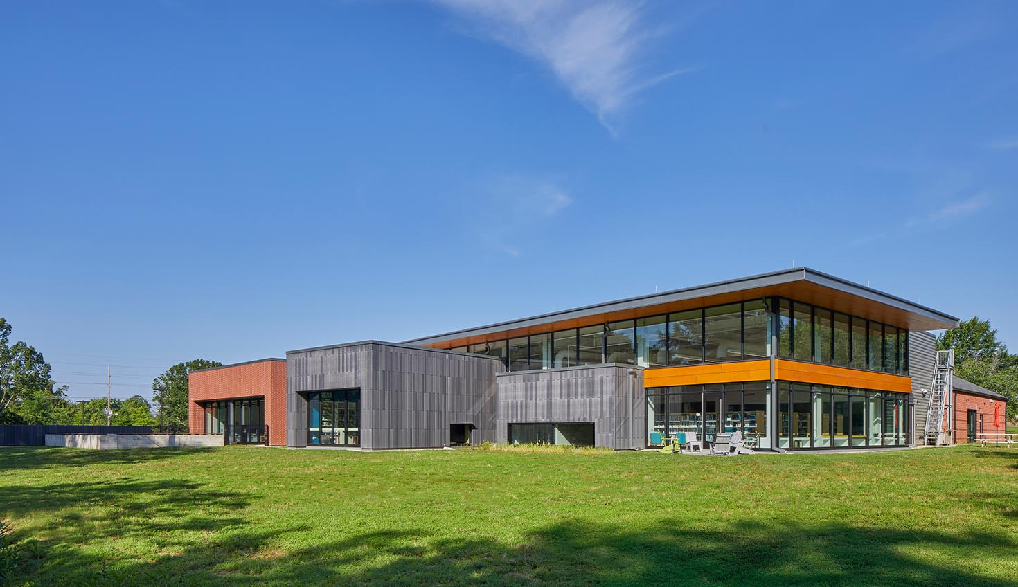 a large building with a grassy field in front of it