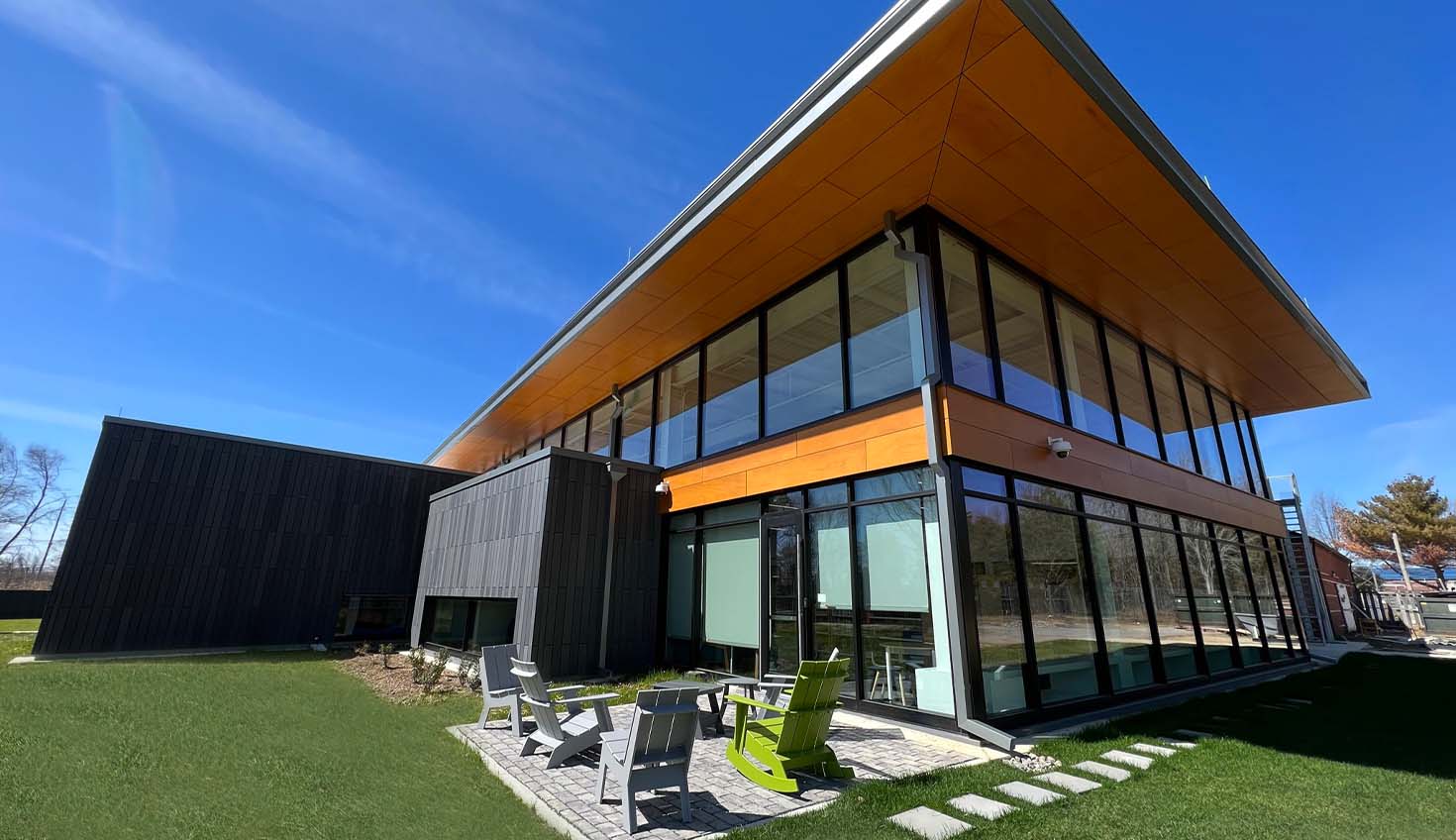 a modern house with a sloping roof and glass walls