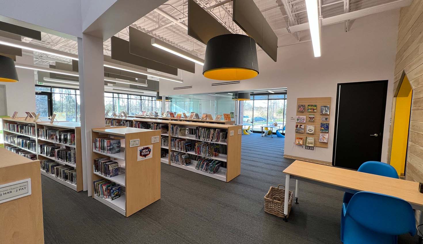 a library filled with lots of books and chairs