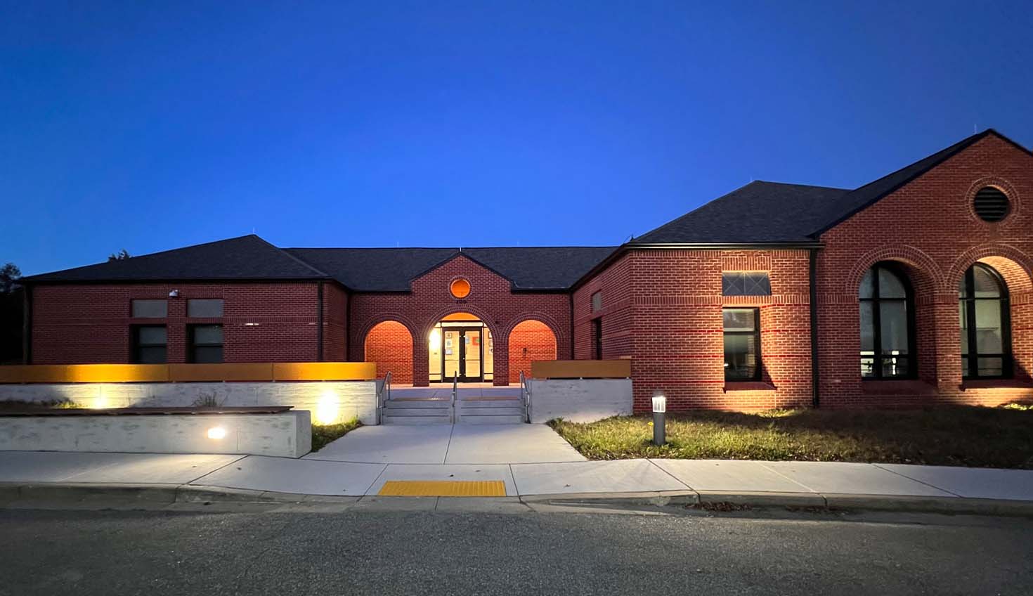 a large brick house lit up at night