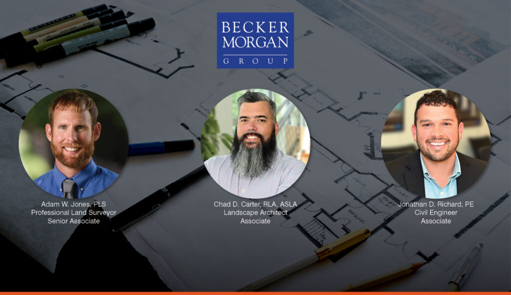 a group of three men sitting next to each other in front of a blueprint