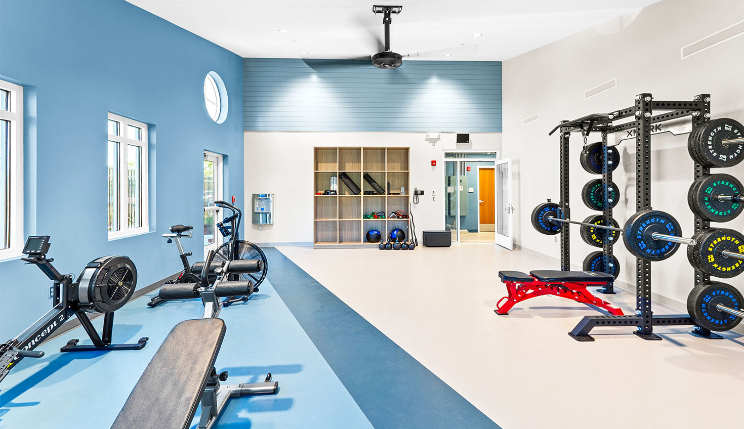 a gym with a row of exercise machines