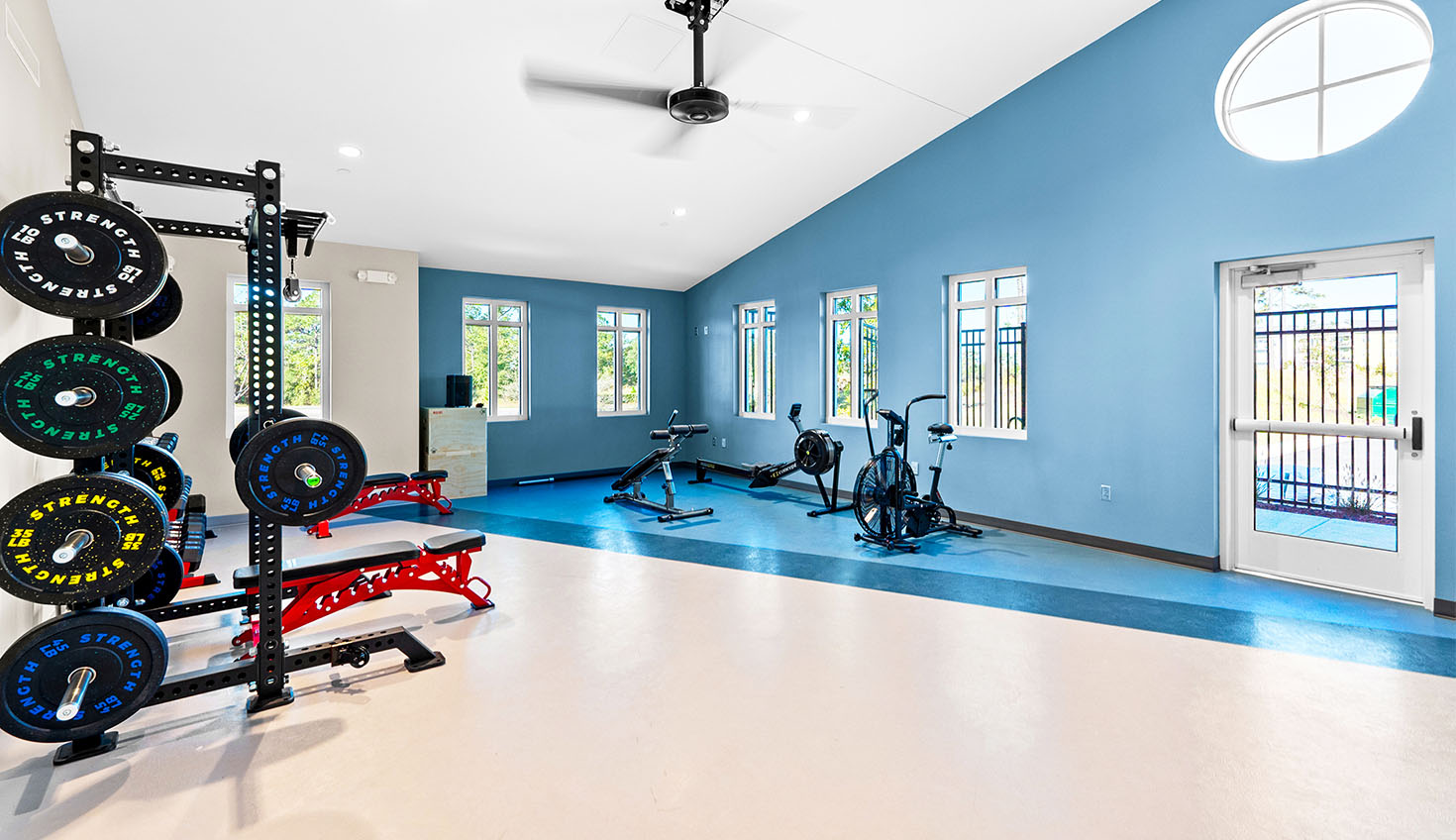 a gym with a blue wall and white floors