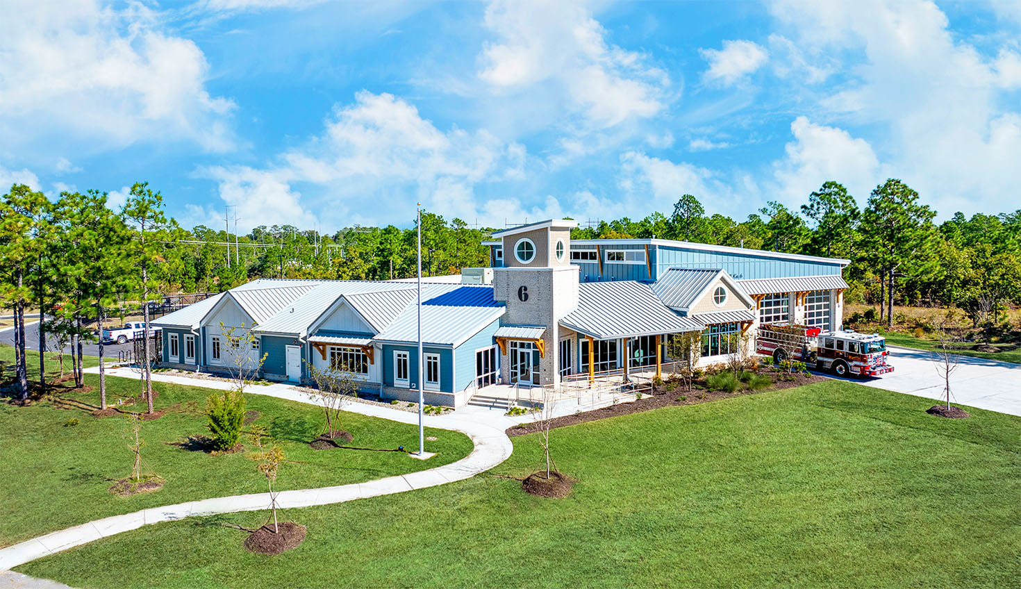 an aerial view of a large blue house