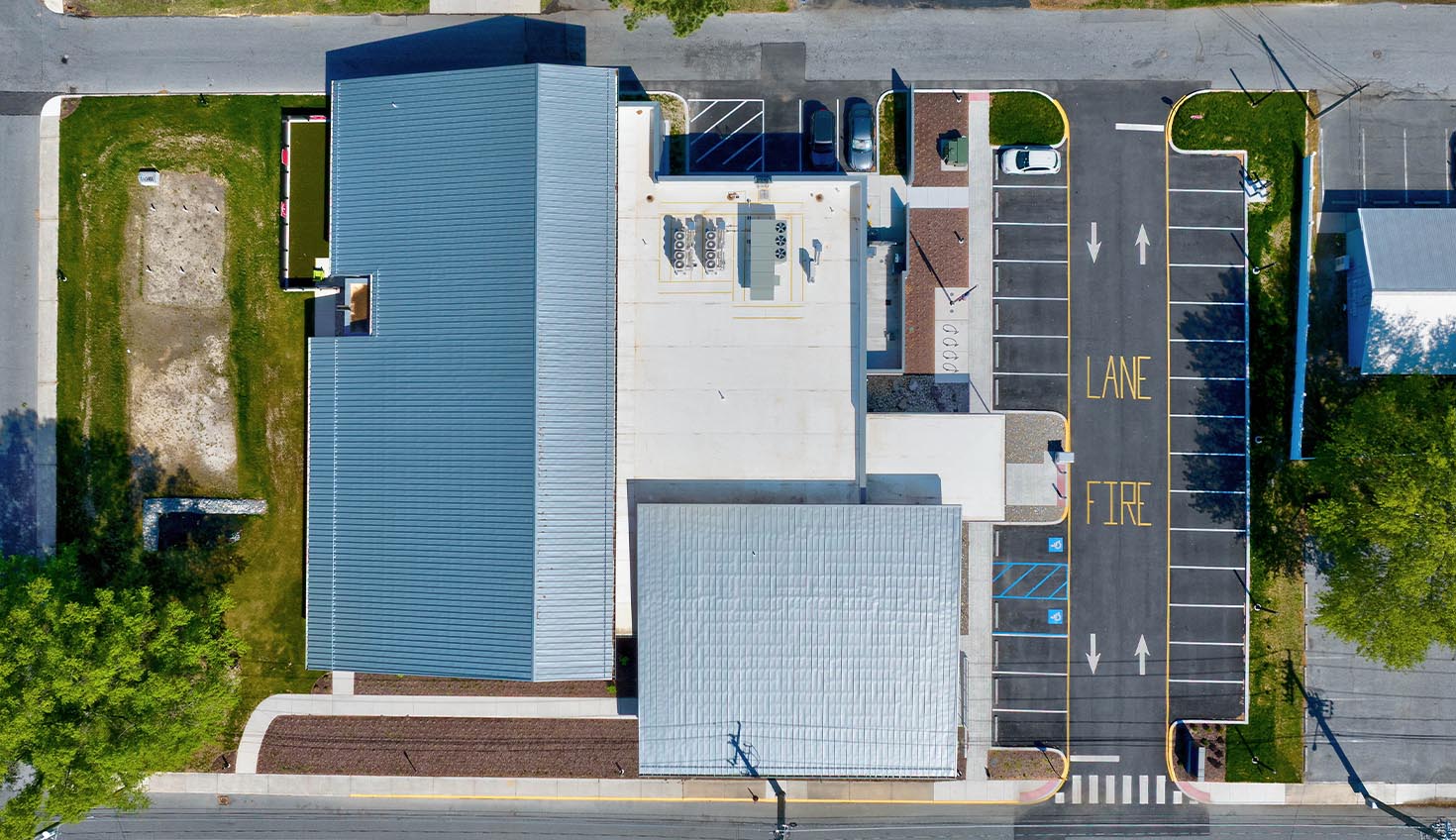 an aerial view of a parking lot and building