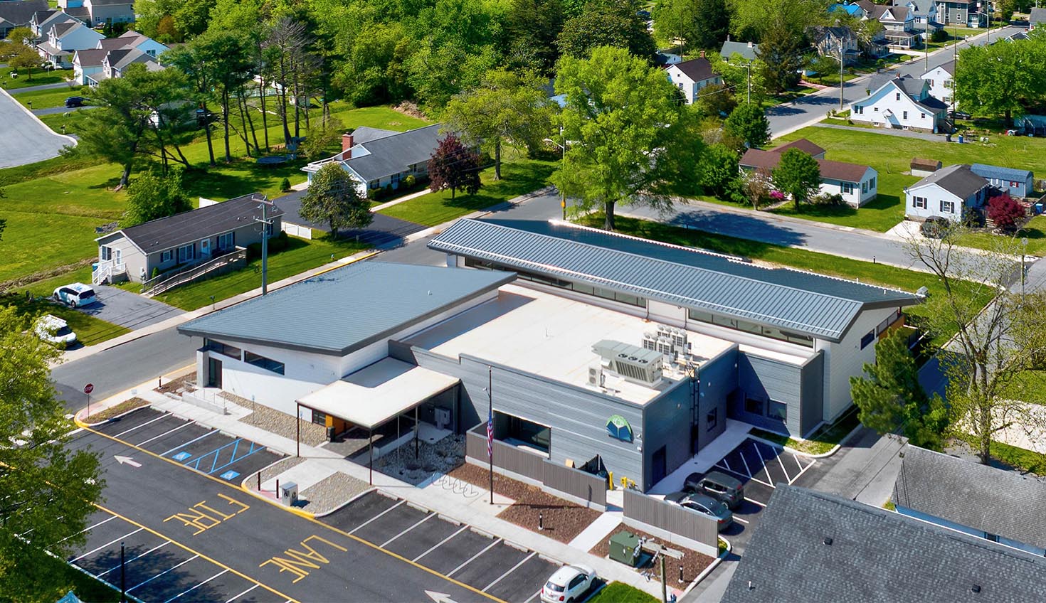 an aerial view of a parking lot in a neighborhood