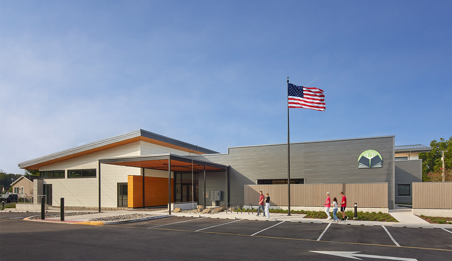 an empty parking lot with a flag flying in the background