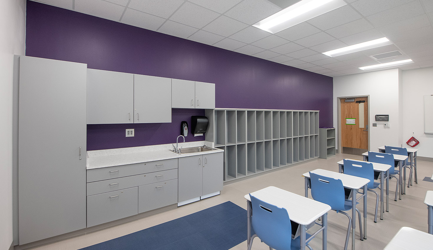 a room with a bunch of desks and chairs
