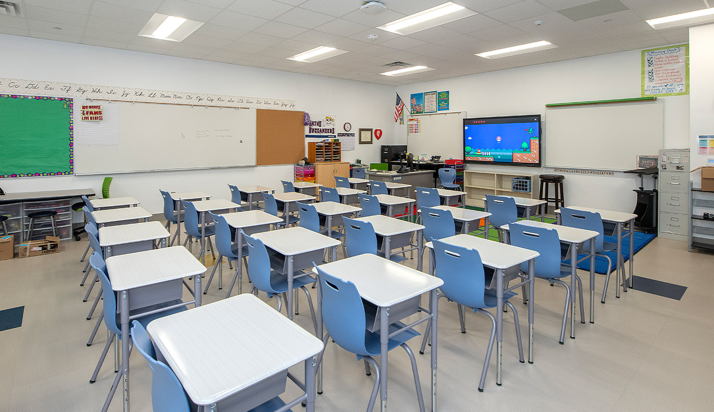 an empty classroom with desks and chairs