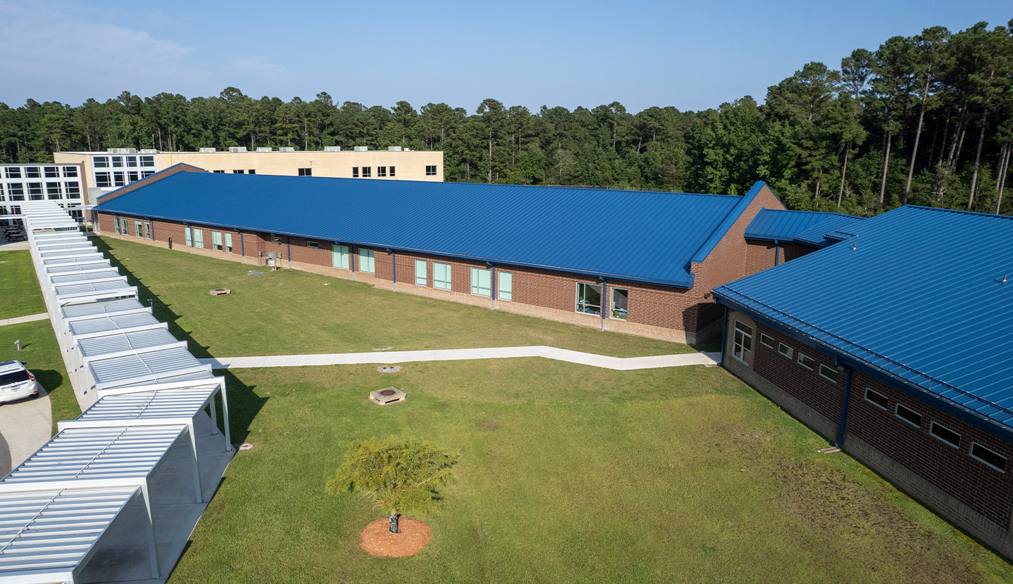 an aerial view of a building with a blue roof