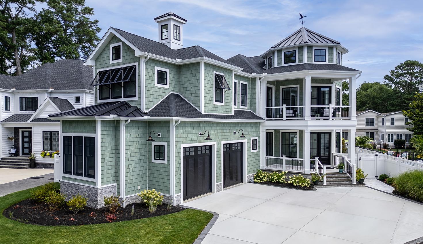 a large house with a lot of windows and a lot of grass