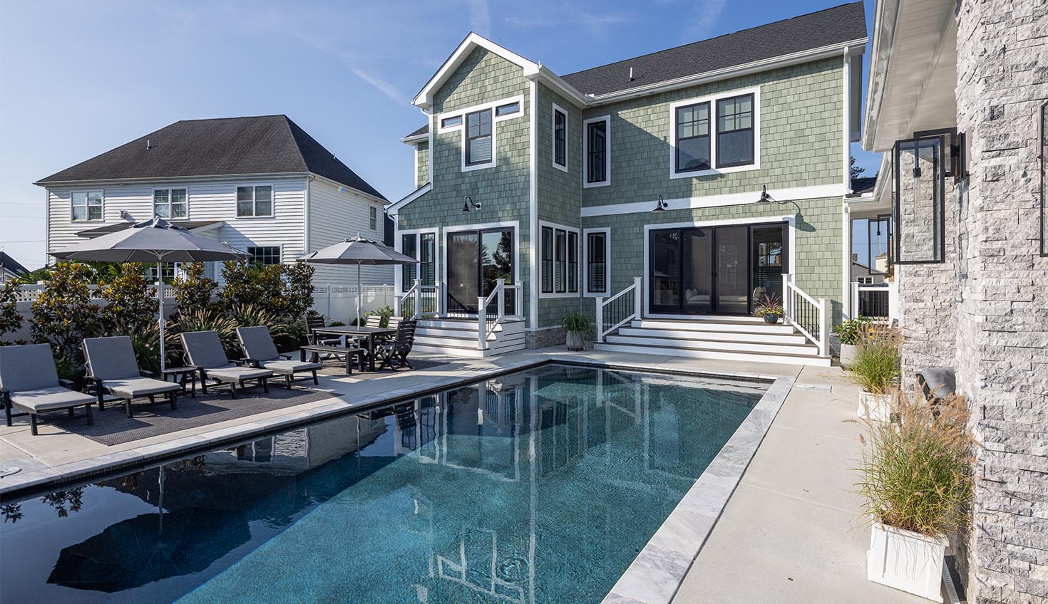 a house with a pool in front of it