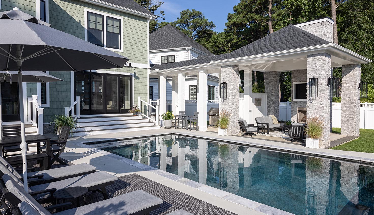 a house with a swimming pool and patio furniture