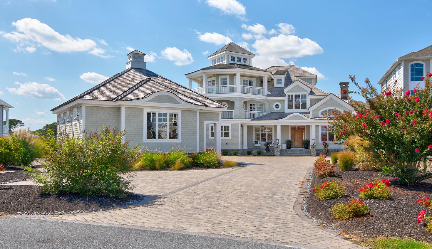 a large white house with a driveway in front of it