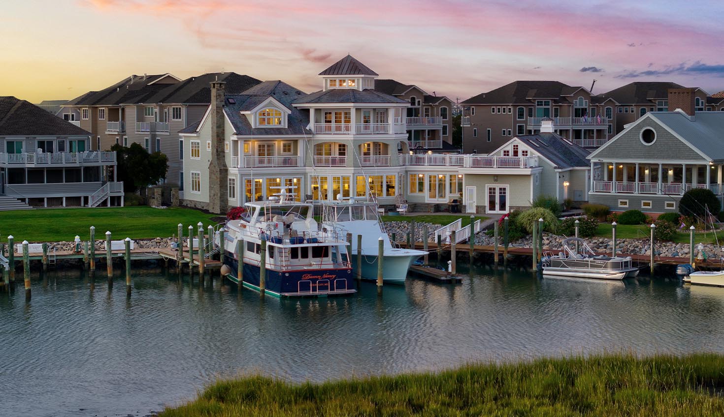 a group of houses sitting next to a body of water