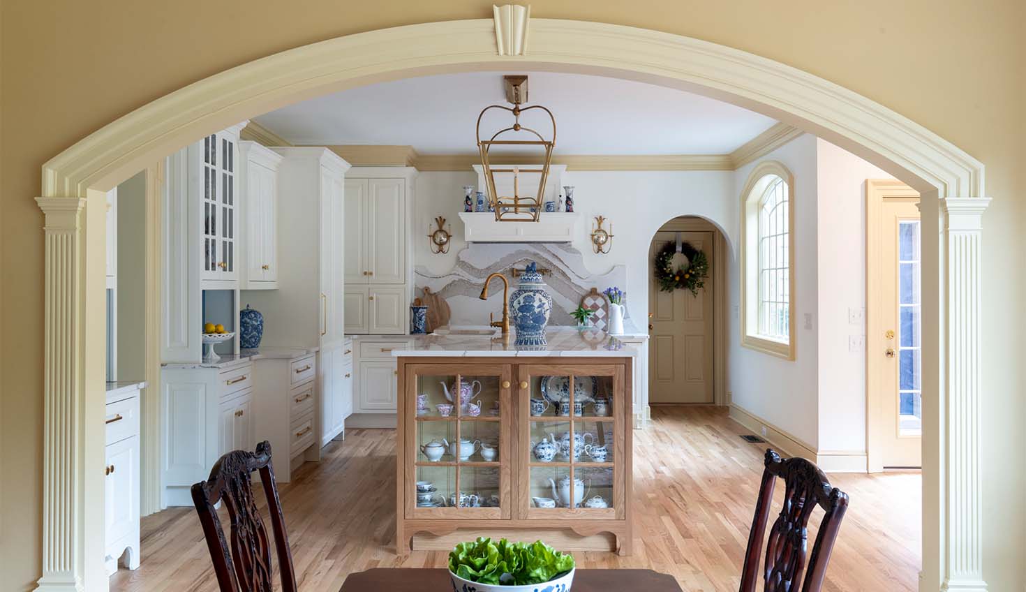 a dining room table with a bowl of vegetables on top of it