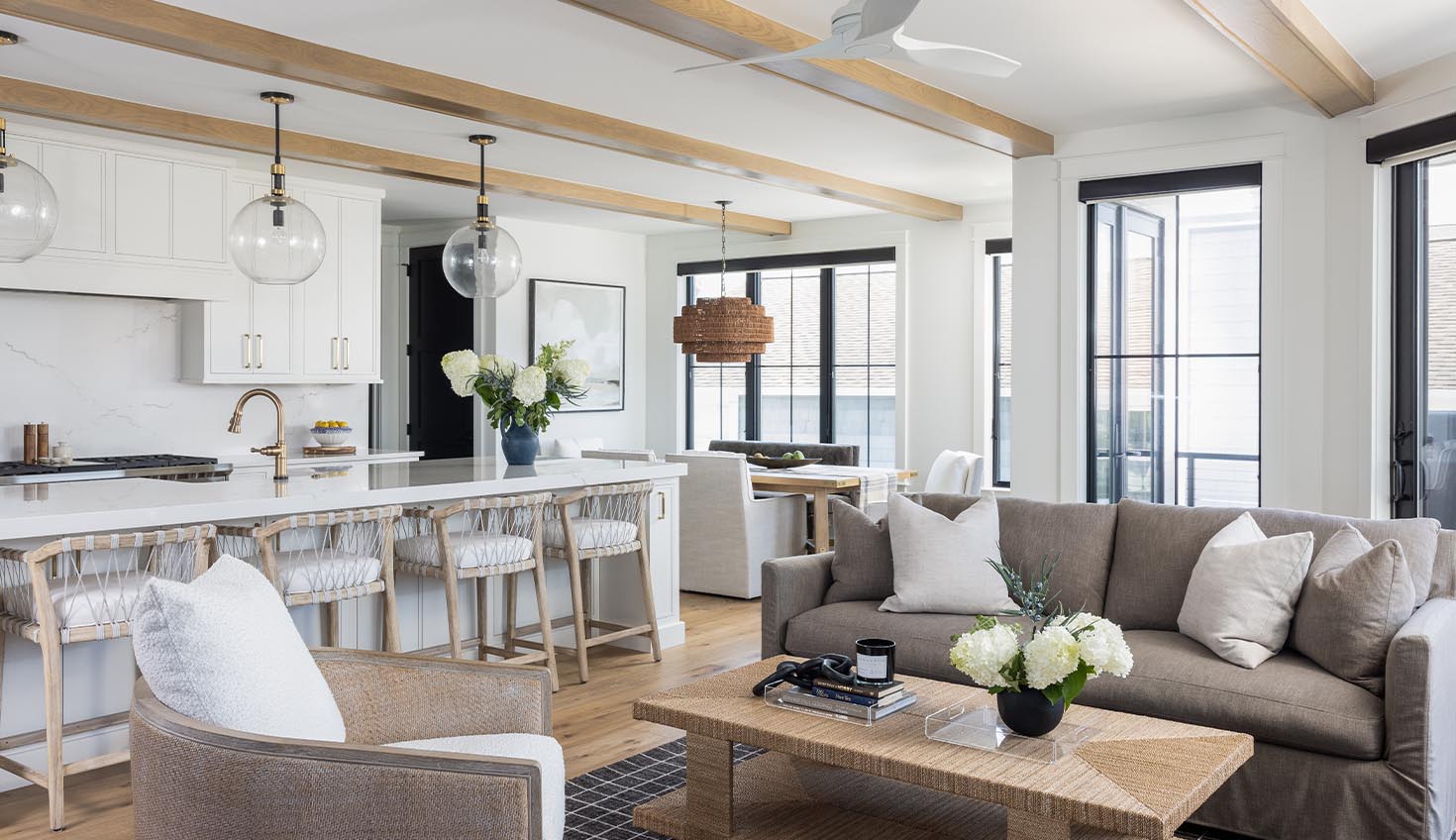 a living room filled with furniture and a kitchen