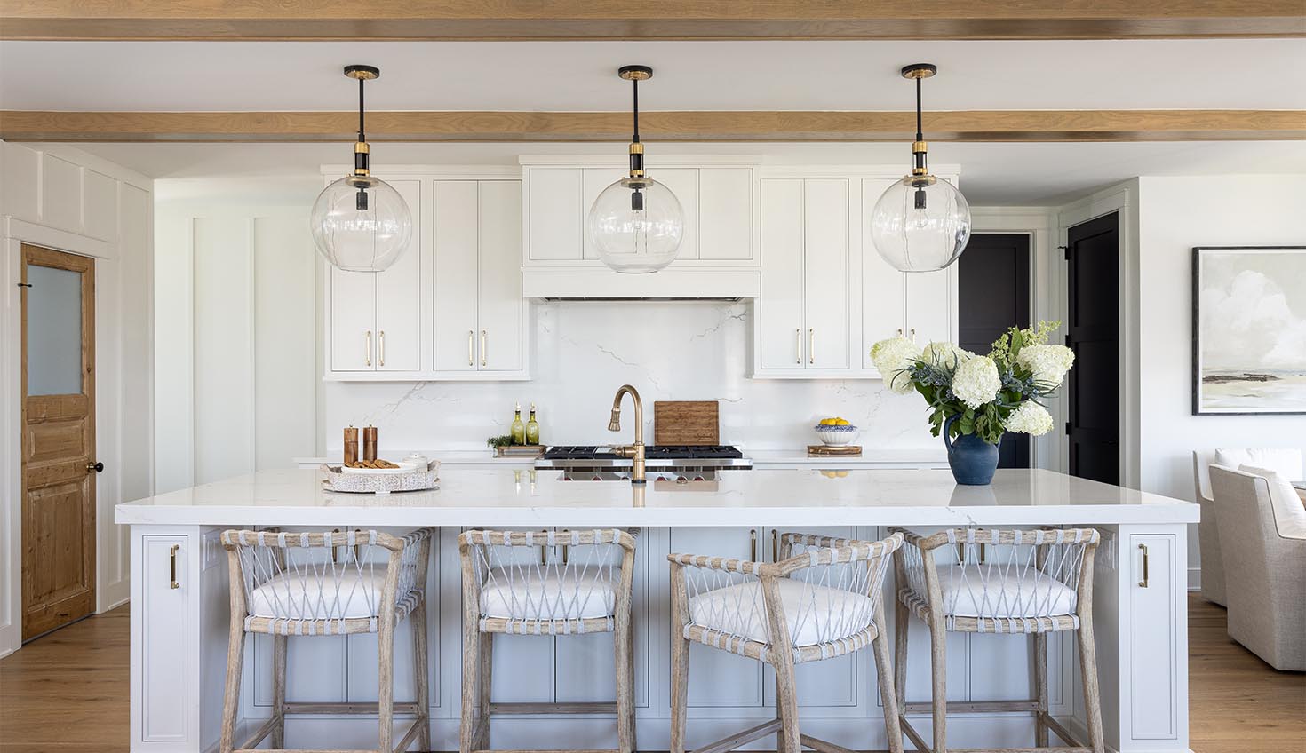 a kitchen with white cabinets and a center island