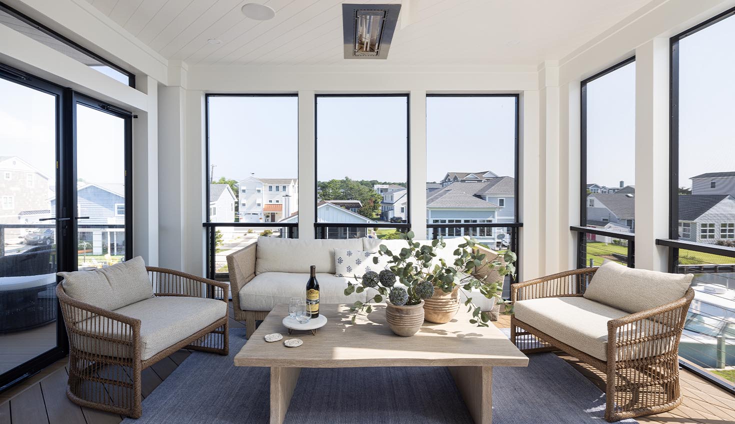 a living room filled with furniture and lots of windows