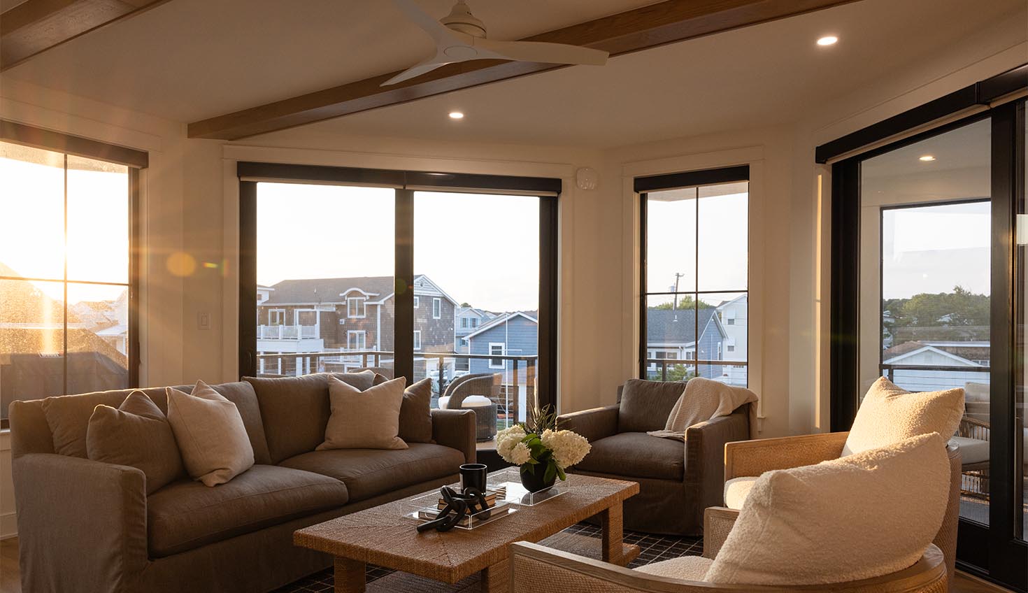 a living room filled with furniture and lots of windows