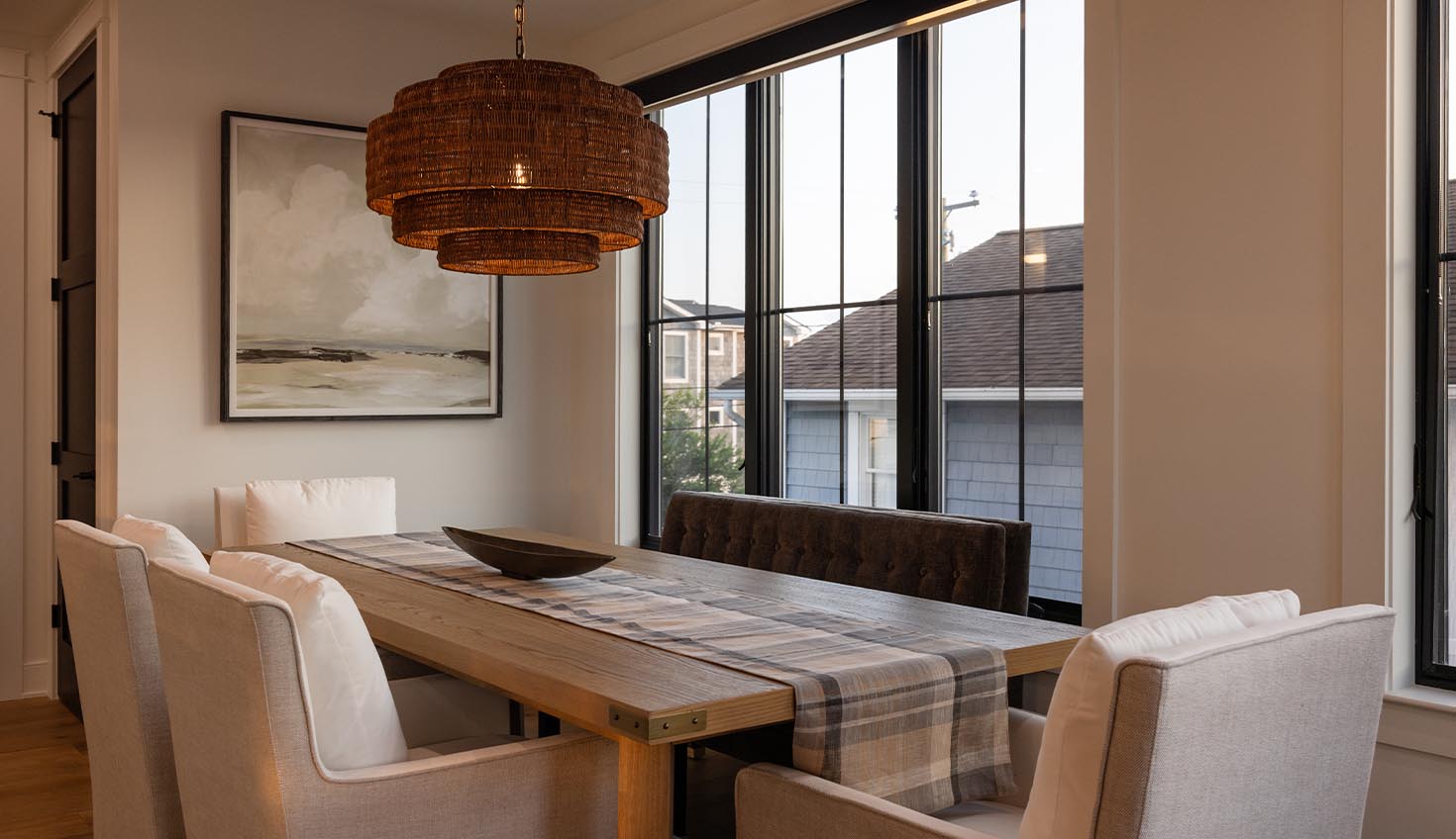 a dining room with a wooden table and chairs