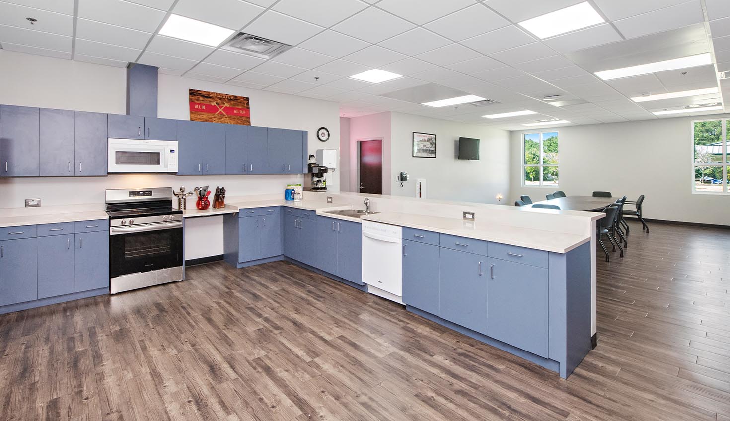 a kitchen with blue cabinets and white counter tops