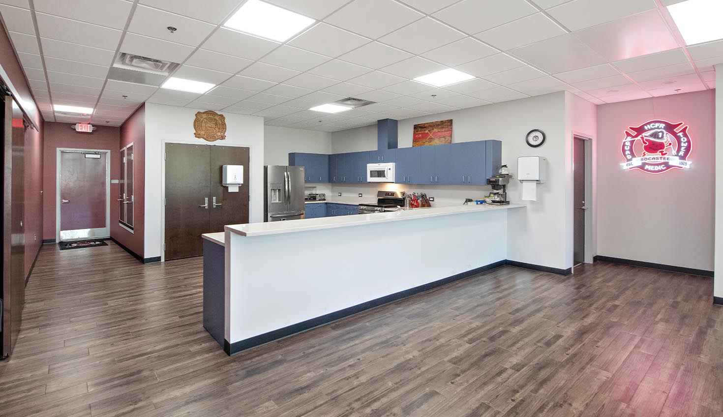 a kitchen with a counter, refrigerator, microwave and microwave oven