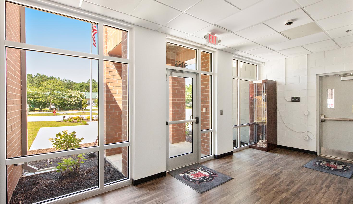a large room with wooden floors and large windows