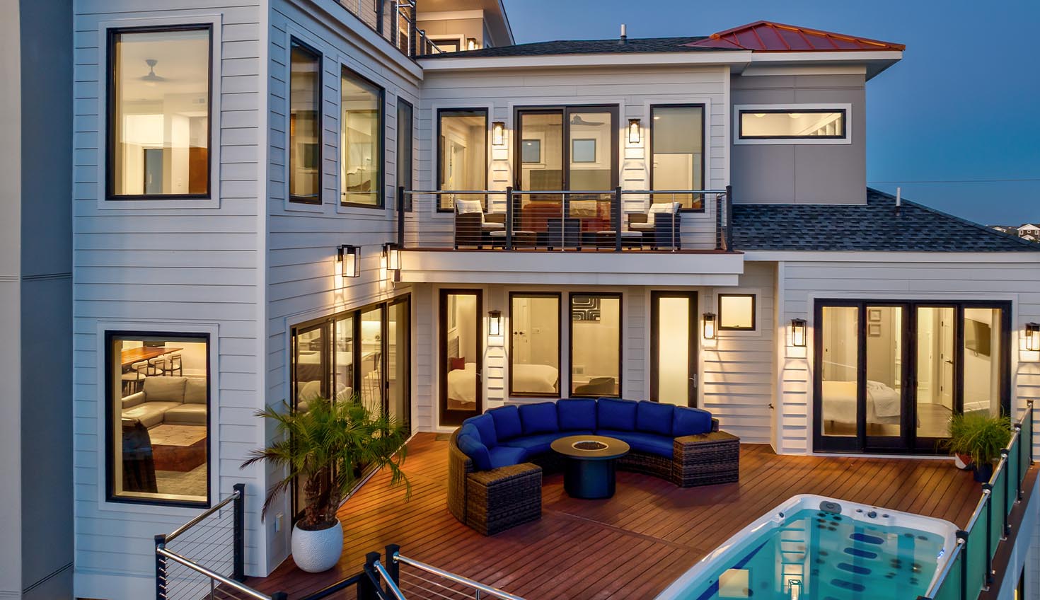 a large white house with a pool in front of it
