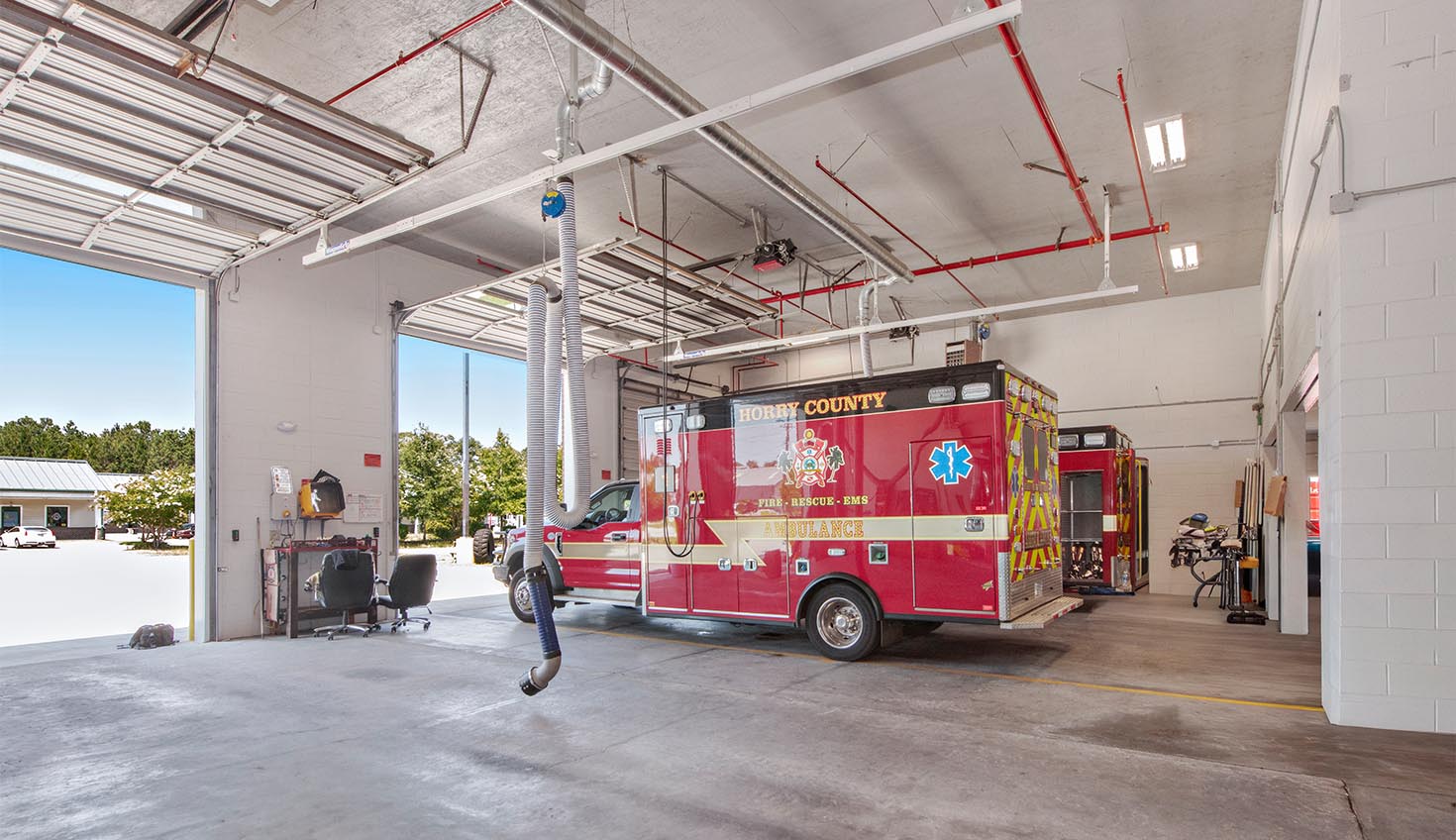 a red fire truck parked inside of a garage