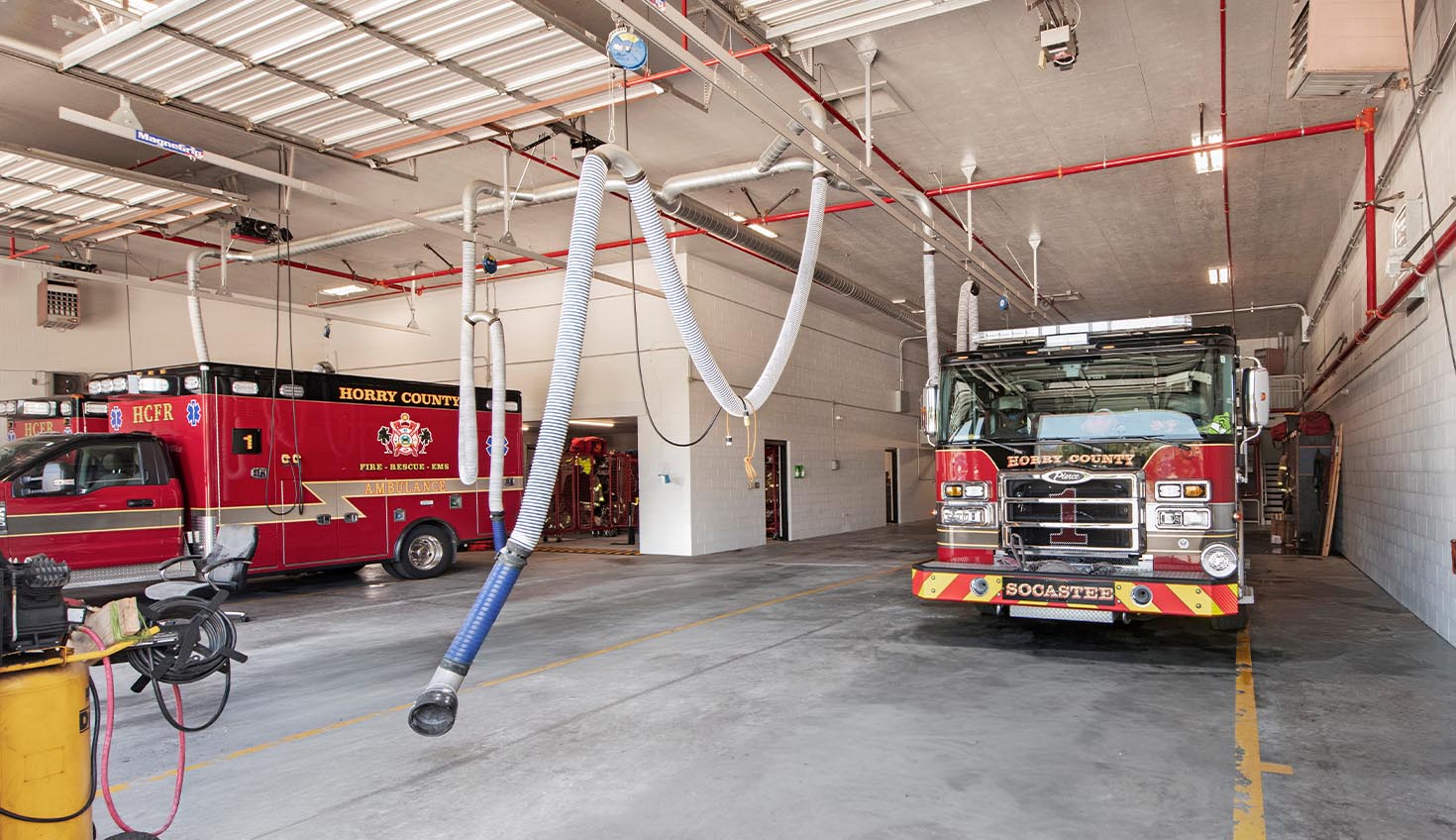 a fire truck parked in a garage next to a fire hydrant