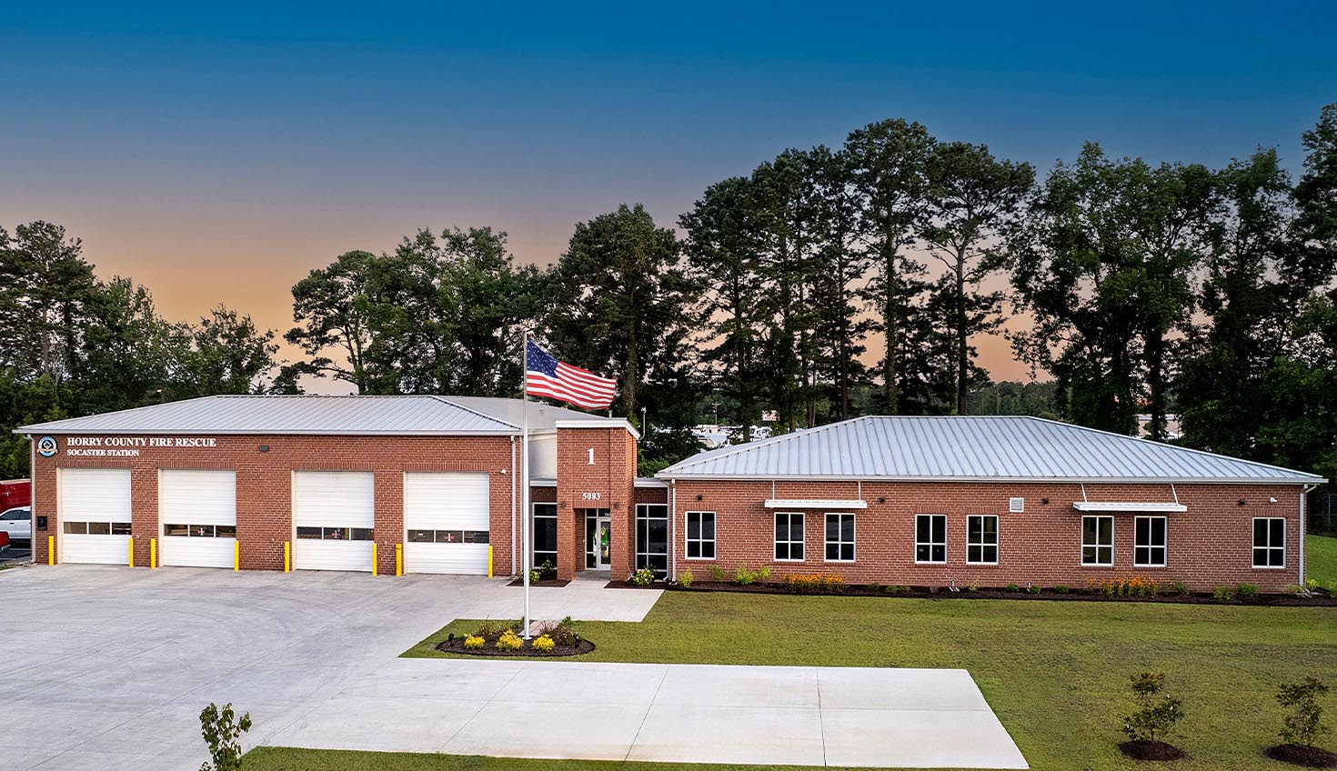 a large brick building with a flag on top of it