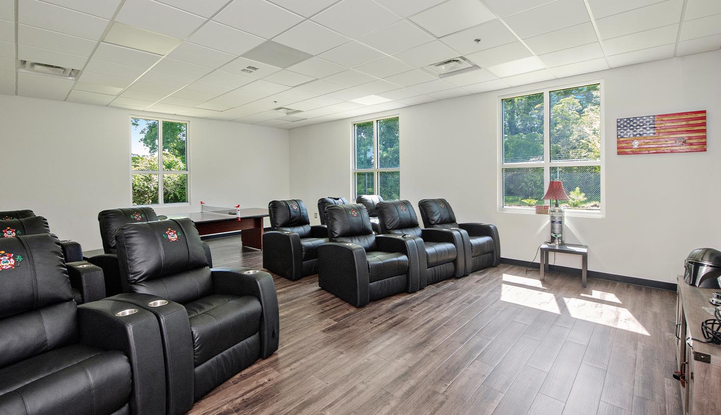 a large room with a row of black chairs