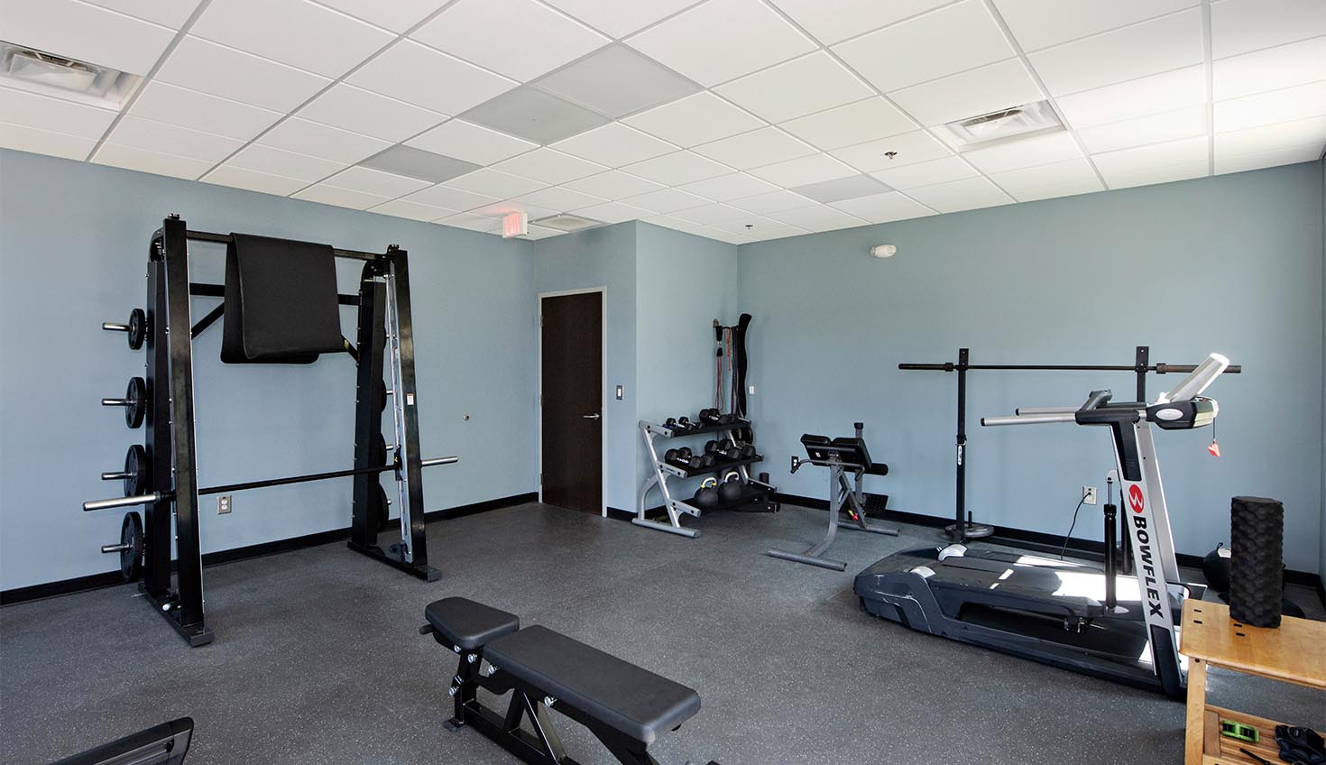 a home gym with equipment and a flat screen tv