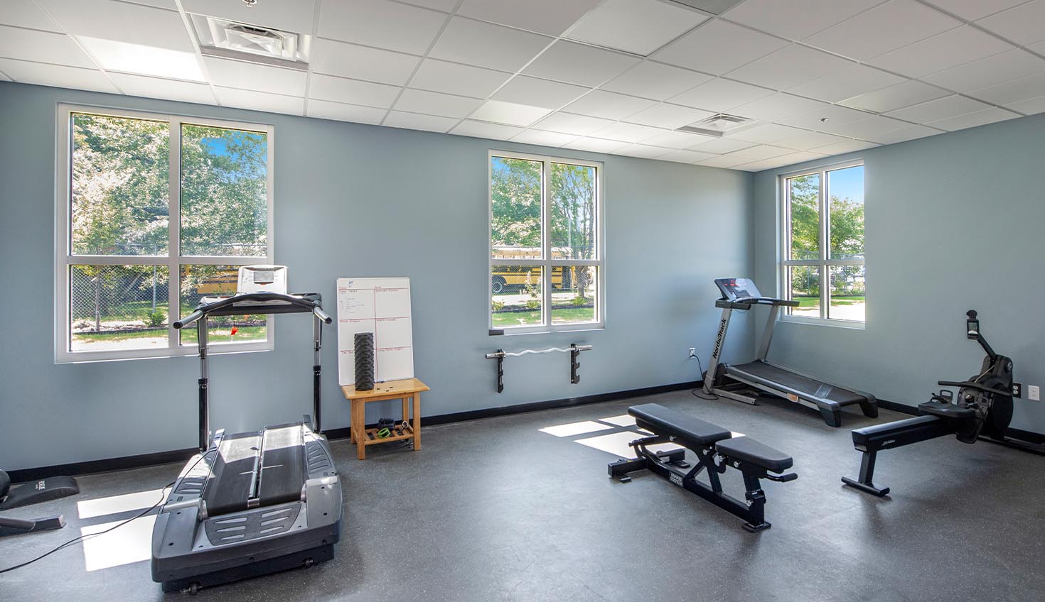 a gym with a treadmill and exercise machines