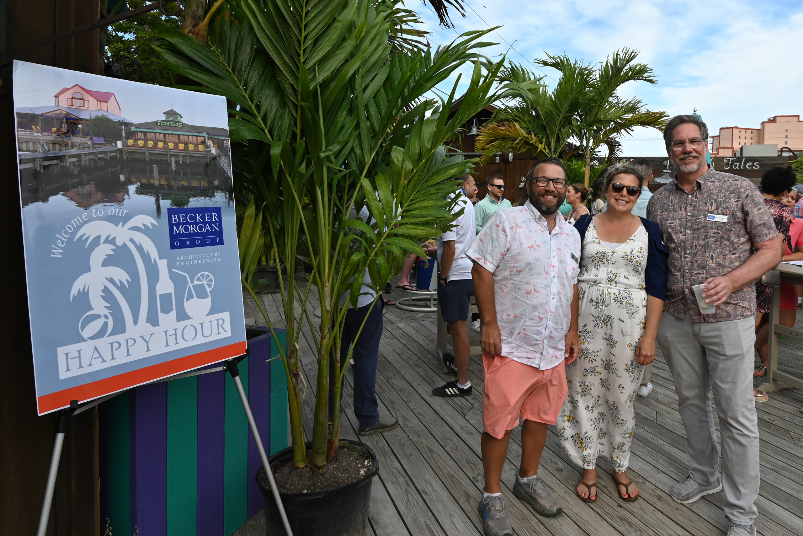 a group of people standing on top of a wooden deck