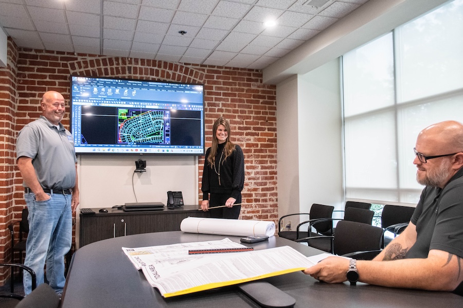 a group of people standing around a table