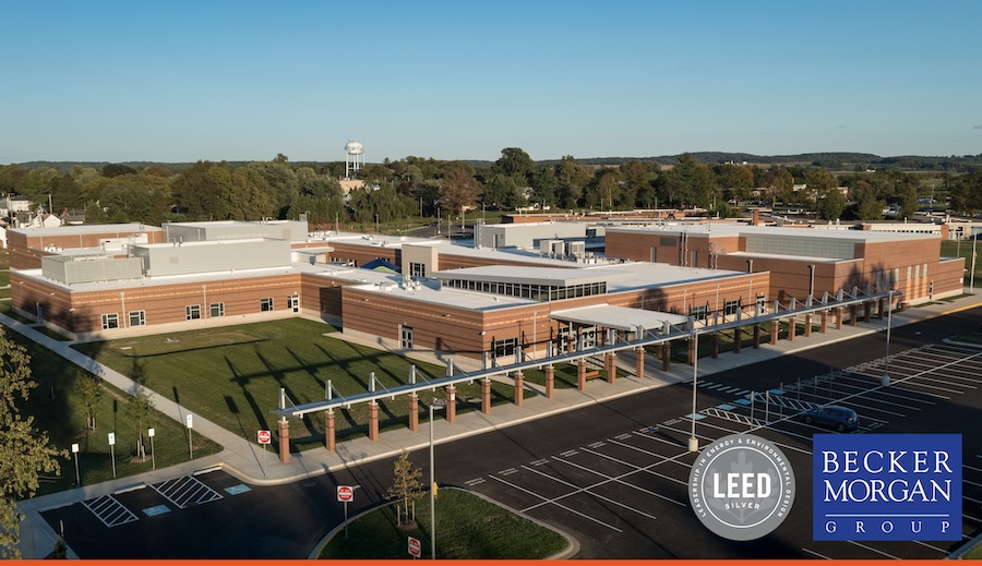an aerial view of a building with a parking lot in front of it