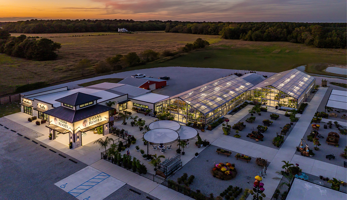 an aerial view of a building with a sunset in the background