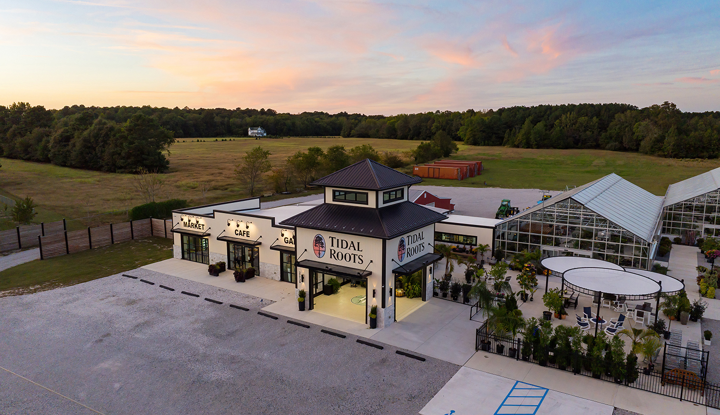 an aerial view of a building with a lot of trees in the background